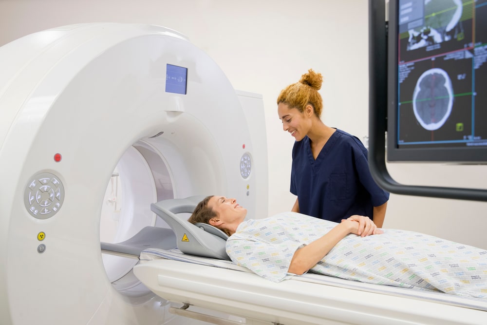 medical professional talking with patient before going into a medical scan