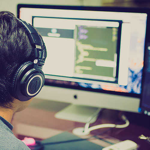 man with headphones and computer monitor