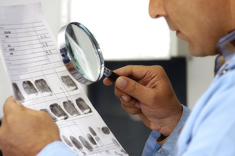 man examining fingerprints