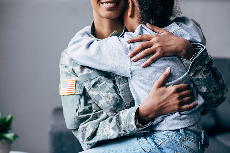 Military mother holding her daughter.