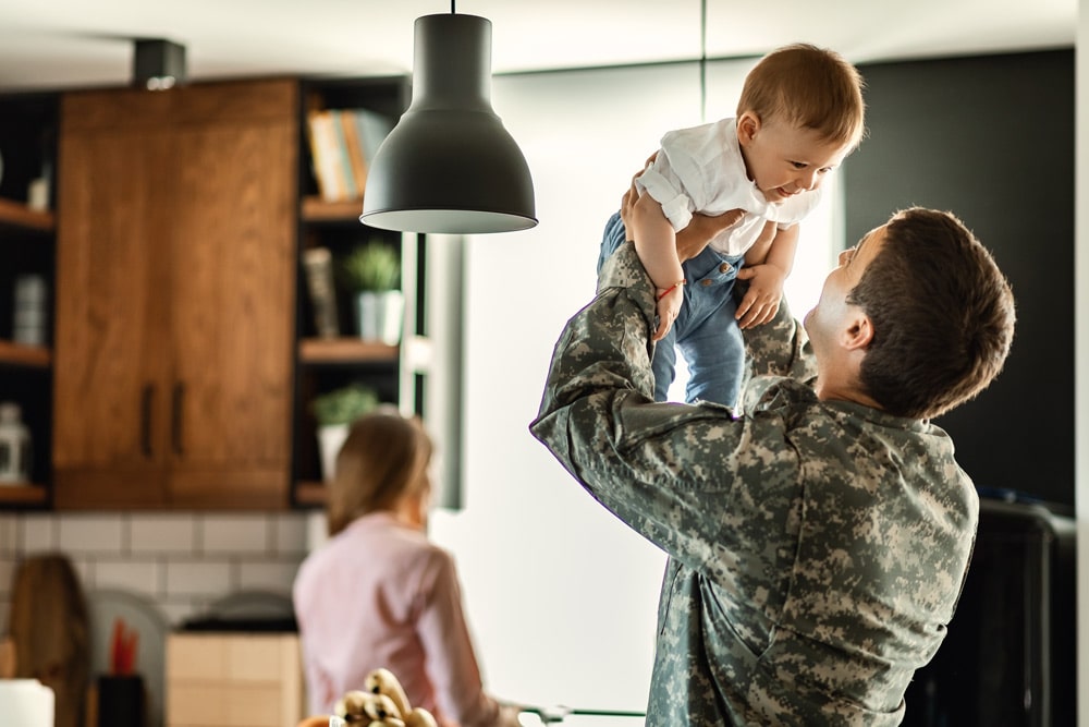 military father holding toddler son