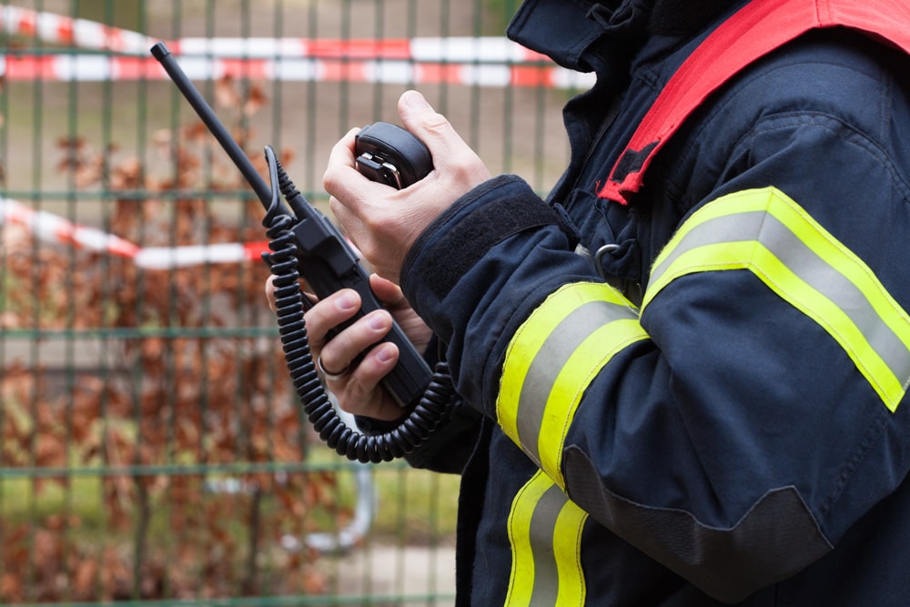 emergency personnel using hand radio