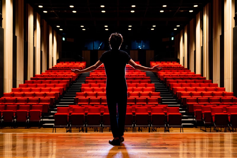 man on stage in theatre