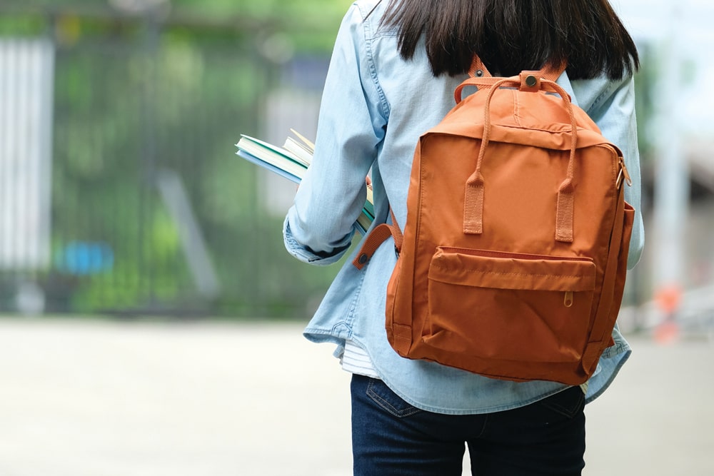 girl walking with backpack