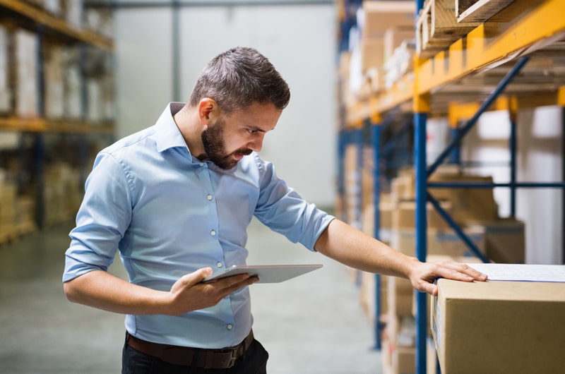 man reviewing inventory inside warehouse