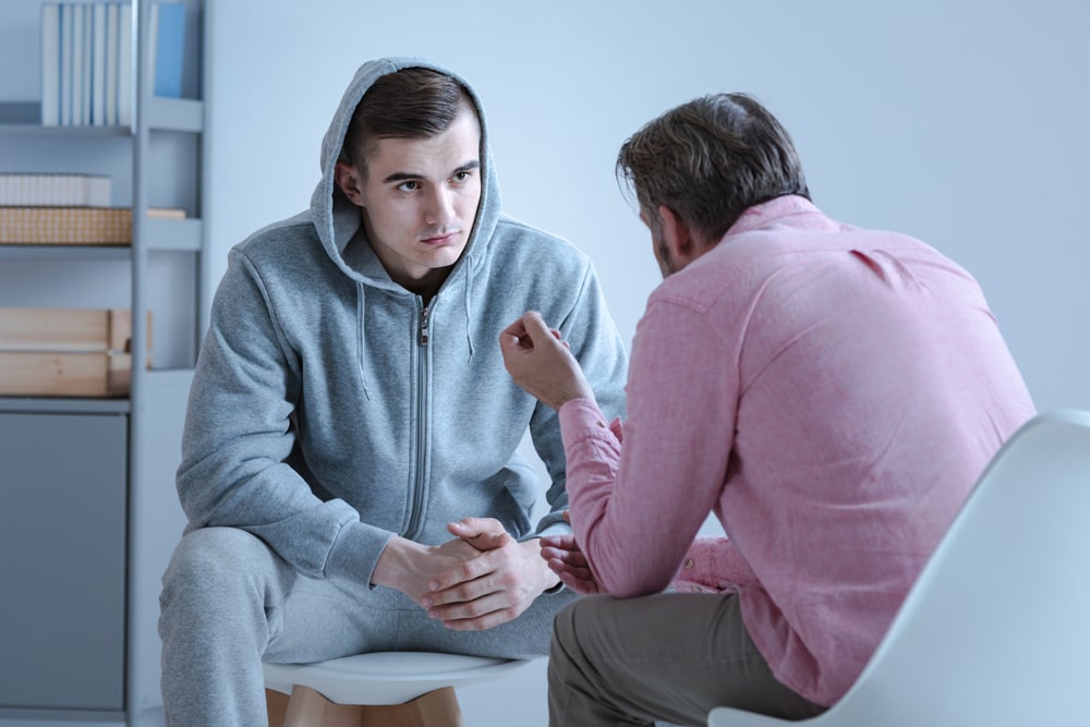 teenage boy talking with counselor