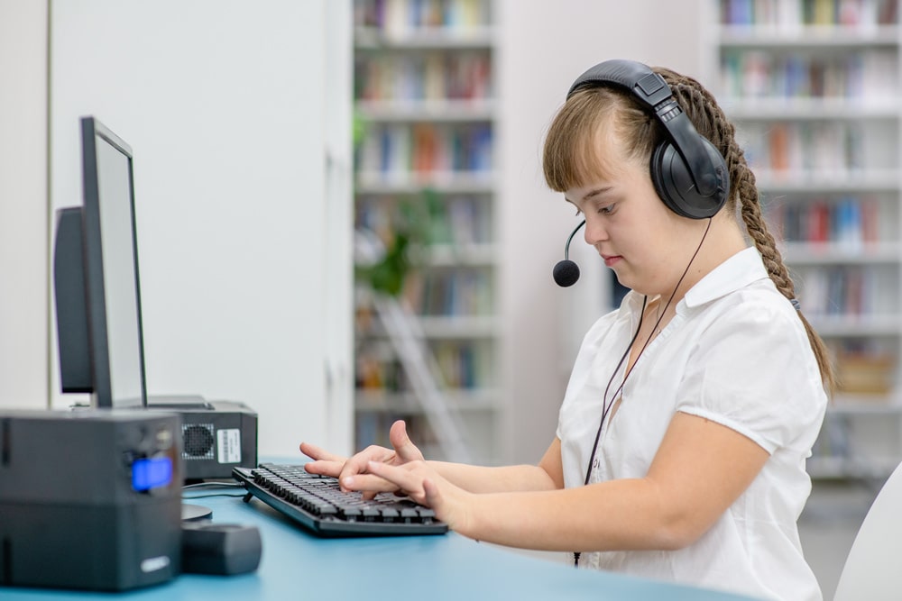 special education student at computer with headset