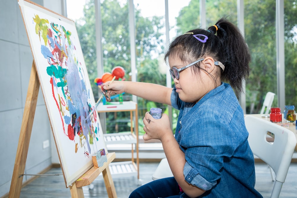 special needs girl painting