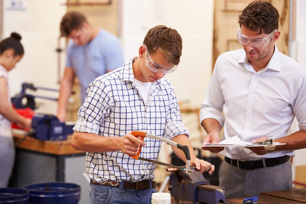 two men working with safety glasses on