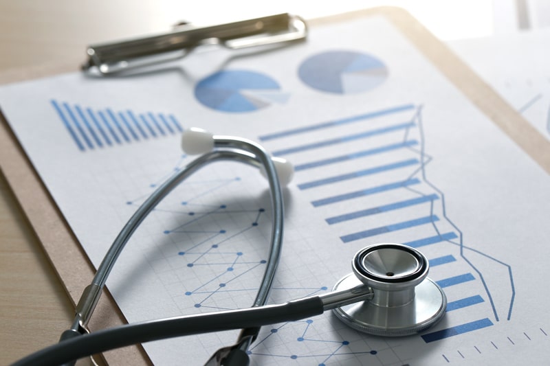 stethoscope on paper with graphs