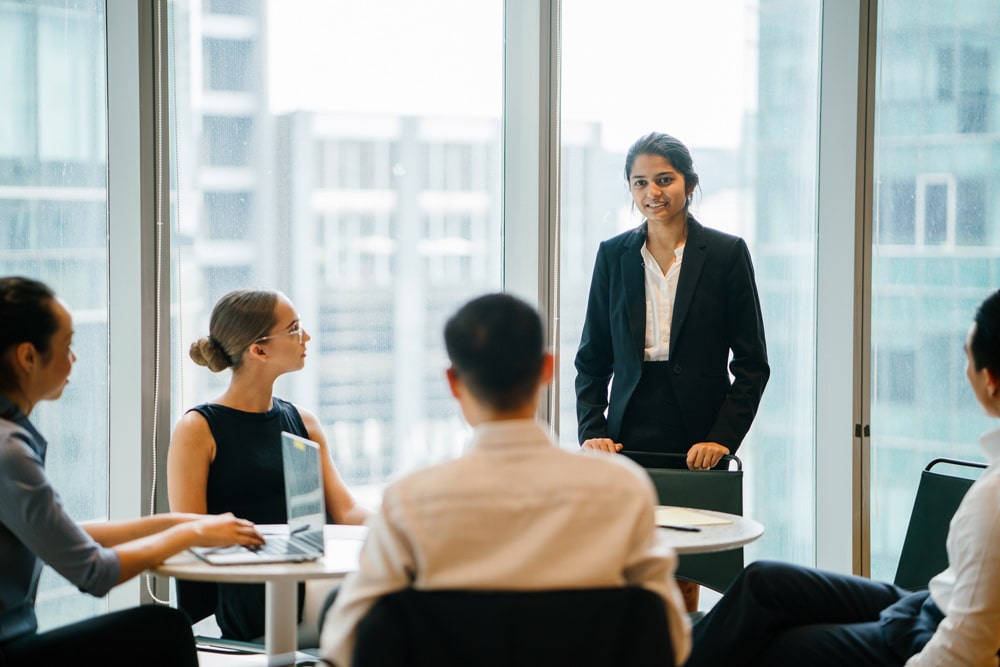 woman standing and talking in meeting