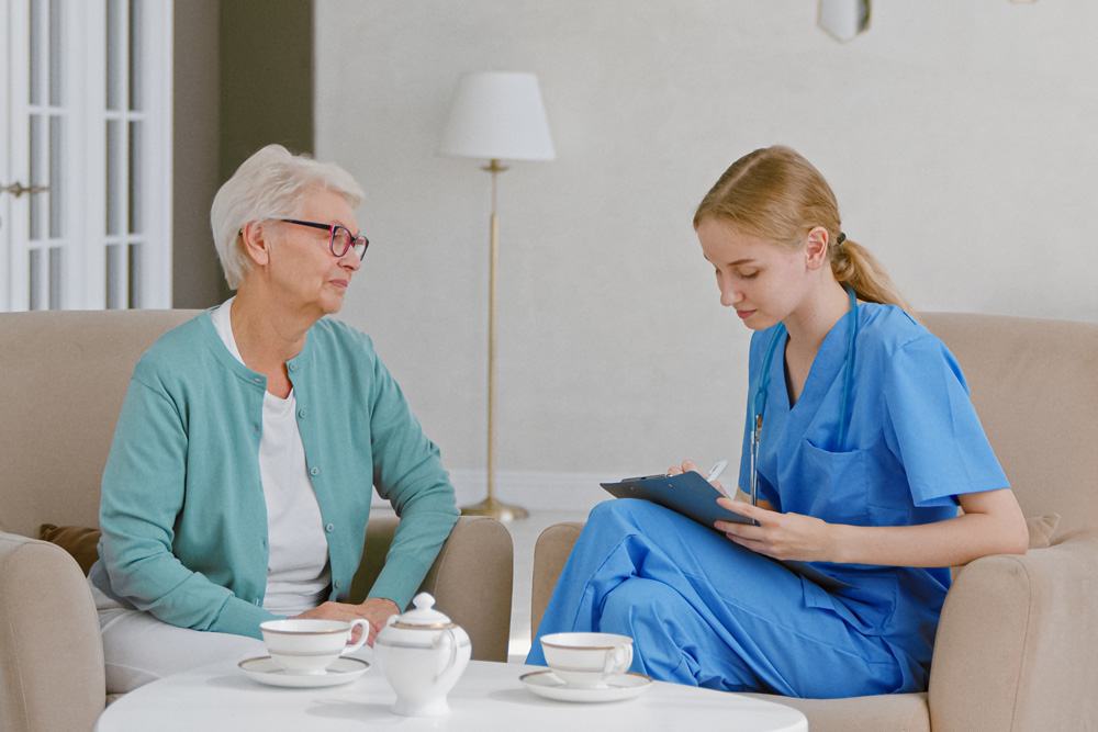 healthcare work talking to elderly woman